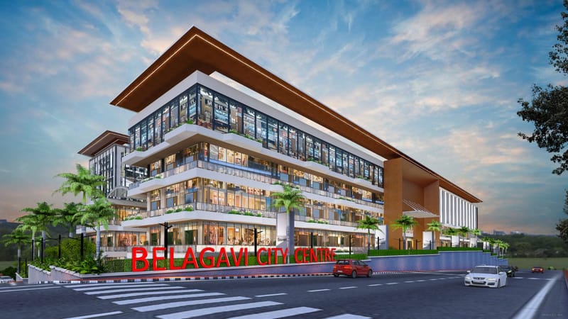 City Central Mall — architectural rendering of the street elevation at dusk, a four-level retail block with a deep cantilevered roof, continuous glazed shopfronts and Belagavi City Centre signage at the entrance.